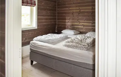 a bedroom with two beds in a room with a window at 4 Bedroom Pet Friendly Home In Eggedal in Eggedal