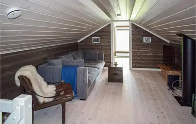 a living room with a bed and a couch in a room at 4 Bedroom Pet Friendly Home In Eggedal in Eggedal