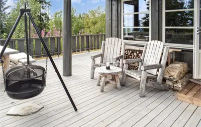 a porch with two chairs and a fire place at 4 Bedroom Pet Friendly Home In Eggedal in Eggedal