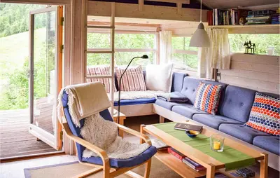 a living room with a blue couch and a table at Beautiful Home In Vossestrand With Wifi in Vossestrand