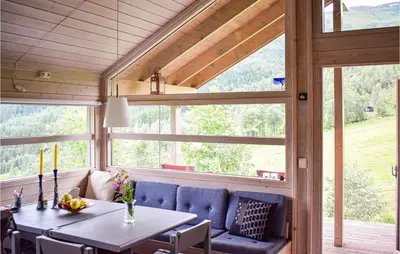 a dining room with a table and a large window at Beautiful Home In Vossestrand With Wifi in Vossestrand