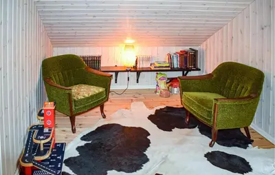 a living room with two chairs and a rug at Cozy Home In Brøttum With Kitchen