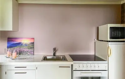 a kitchen with a sink and a microwave at 1 Bedroom Amazing Apartment In Øydegard in Aspa