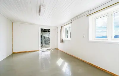 an empty room with white walls and windows at 5 Bedroom Amazing Home In Strandebarm in Strandebarm