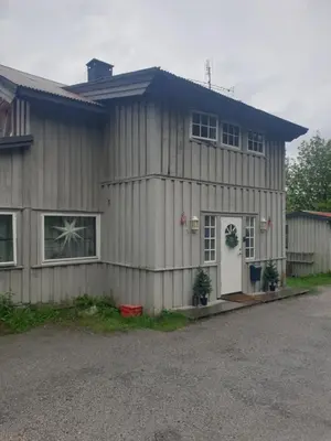 a house with a white door on the side of it at Holiday Rooms in Gol