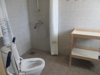 a bathroom with a toilet and a shower at Skåbu Camping in Skåbu