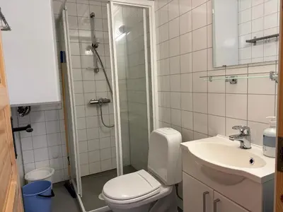 a bathroom with a shower and a toilet and a sink at Skåbu Camping in Skåbu