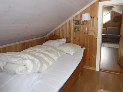 a bed with white sheets and pillows in a room at Ny hytte i flott turterreng in Nore