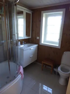 a bathroom with a tub and a sink and a toilet at Ny hytte i flott turterreng in Nore