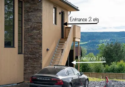 a car parked in front of a house with a staircase at Sanns villa in Lillehammer