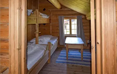 a bedroom with bunk beds in a log cabin at Låven in Rauland