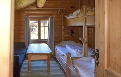 a bedroom with bunk beds in a wooden cabin at Låven in Rauland