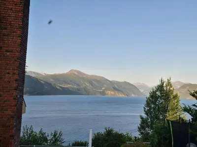 a view of a large body of water with mountains at Stranda apartment in Stranda
