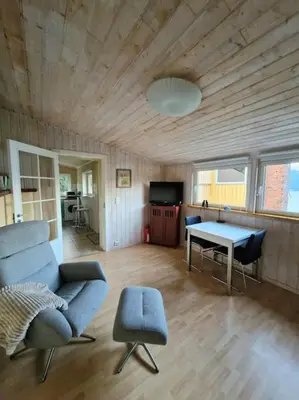 a living room with a couch and a table at Stranda apartment in Stranda