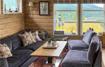 a living room with a couch and a table at Nice Home In Rjukan With Wifi in Rjukan