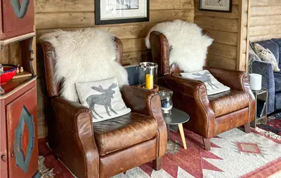 two leather chairs and a table in a room at Nice Home In Rjukan With Wifi in Rjukan