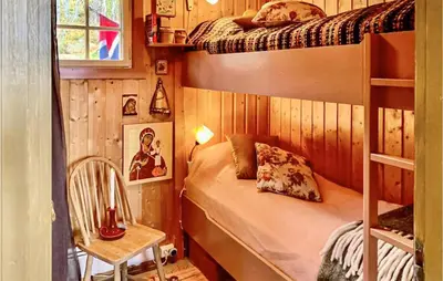 a bedroom with two bunk beds and a chair at Beautiful Home In Uvdal With Kitchen in Uvdal