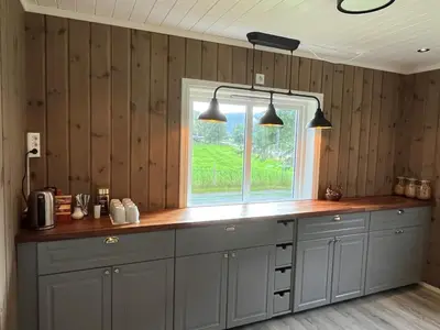 a kitchen with gray cabinets and a window at Nørdre-Repp in Boverdalen