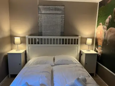a bedroom with a white bed with two night stands at Nørdre-Repp in Boverdalen