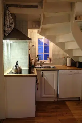 a kitchen with white cabinets and a sink and a window at Charming Bergen house, rare historic house from 1779, Whole house in Bergen