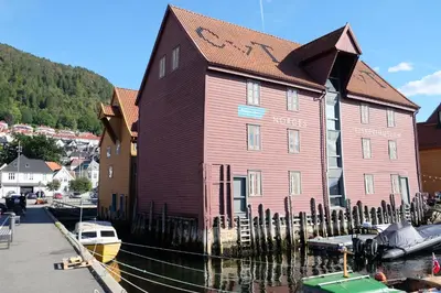 a large red building sitting next to a marina at Charming Bergen house, rare historic house from 1779, Whole house in Bergen