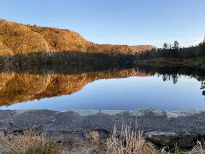 a reflection of a mountain in a lake at Charming Bergen house, rare historic house from 1779, Whole house in Bergen