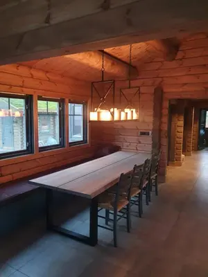 a dining room with a large wooden table and chairs at Trysilsetra 35 in Trysil