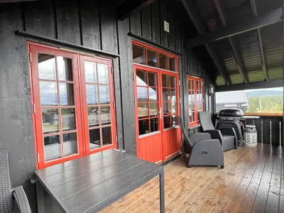 a room with a table and chairs on a house at Stadionutsikten in Beitostøl