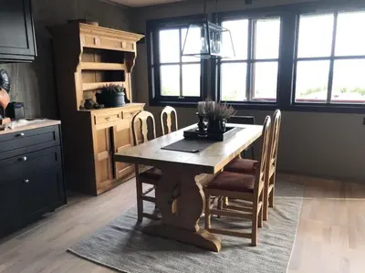 a kitchen with a wooden table and chairs at Beitotind sentralt på Beitostølen in Beitostøl