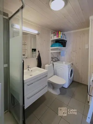 a bathroom with a sink and a toilet and a shower at Family friendly cabin Hemsedal GolfAlpin golf, ski-out, fireplace & wifi in Hemsedal