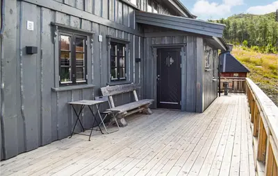 a wooden deck with a bench on a building at Stunning Home In Rauland With Sauna in Rauland