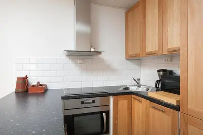 a kitchen with a stove and a sink at Bjorli Apartment 203 (200m til Skitrekk) in Bjorli