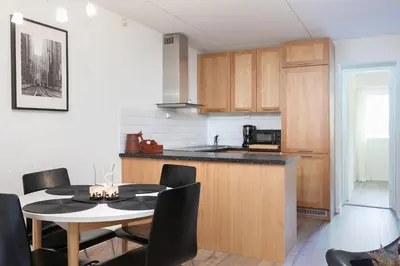 a kitchen and dining room with a table and chairs at Bjorli Apartment 203 (200m til Skitrekk) in Bjorli