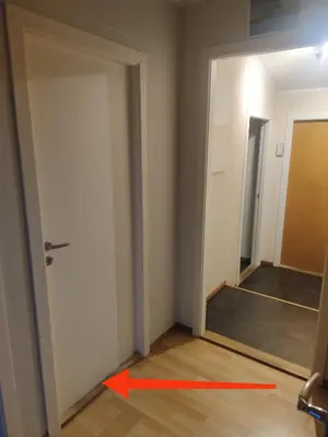 an empty room with a door and a red arrow at Guest room in private house in Ålesund