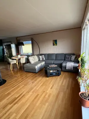 a living room with a couch and a table at Guest room in private house in Ålesund