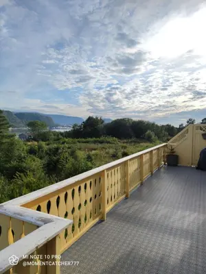 a balcony with a view of the mountains at Guest room in private house in Ålesund