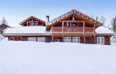 a log cabin in the snow with snow at Cozy Home In Rjukan With Kitchen in Rjukan