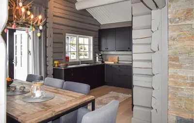 a kitchen and dining room with a wooden table and chairs at Beautiful Home In Rauland With Sauna in Rauland