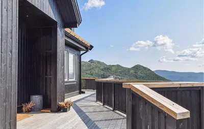 a wooden deck with a view of the mountains at Awesome Home In Rauland With Wifi in Rauland