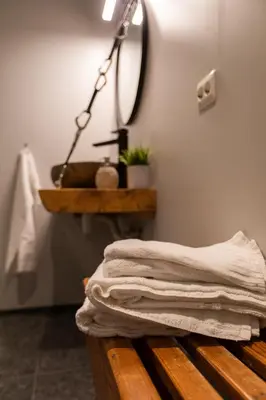 a stack of towels sitting on a bench in a bathroom at Lodgen Stryn in Stryn