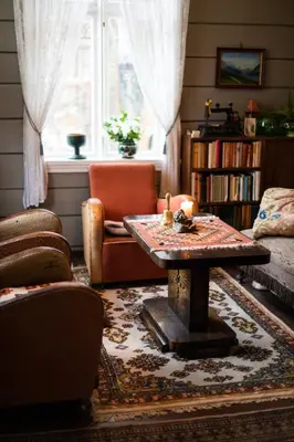 a living room with a table and a window at Lodgen Stryn in Stryn