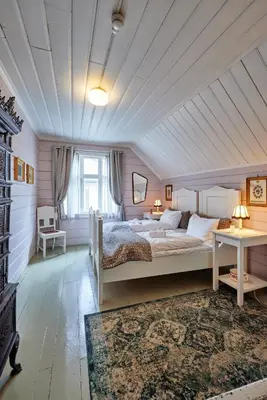 a bedroom with a large bed and a table at Lodgen Stryn in Stryn
