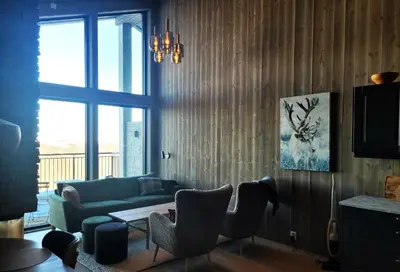 a living room with a couch and a table at Gausta Residence in Gaustablikk