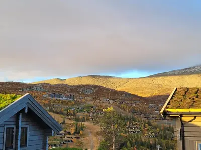 a view of a town with mountains in the background at Gausta Residence in Gaustablikk