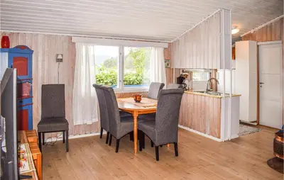 a kitchen with a table and chairs in a room at 3 Bedroom Awesome Home In Vikersund in Vikersund