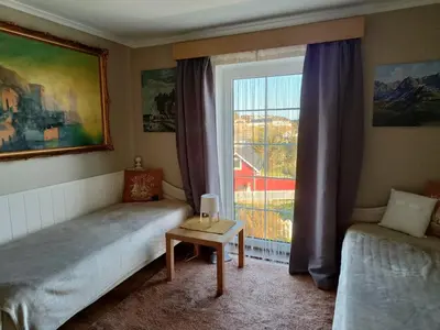 a bedroom with two beds and a window at Apartment , Øygarden, Bergen in Torsteinsvik