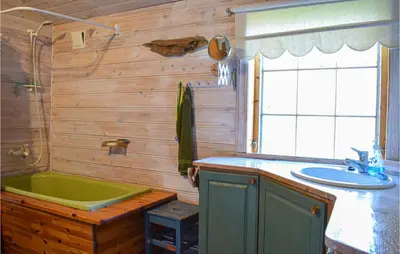 a bathroom with a green tub and a sink at Gorgeous Home In Aksdal With Kitchen in Aksdal