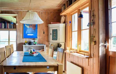 a dining room with a wooden table and chairs at Gorgeous Home In Aksdal With Kitchen in Aksdal