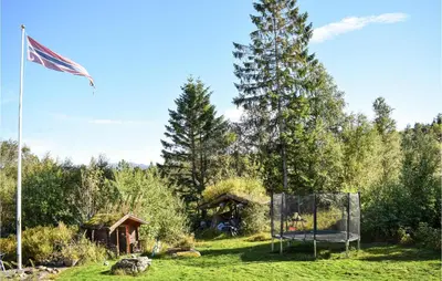 a flag and a basketball hoop in a yard with a tree at Gorgeous Home In Aksdal With Kitchen in Aksdal