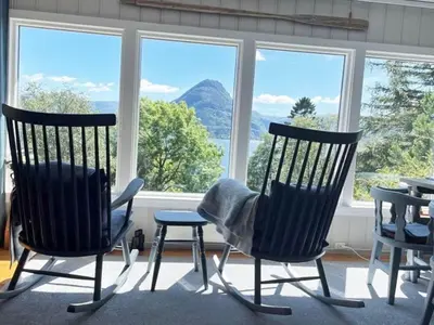 two chairs and a stool in front of a window at 4 person holiday home in Svelgen-By Traum in Sørgulen